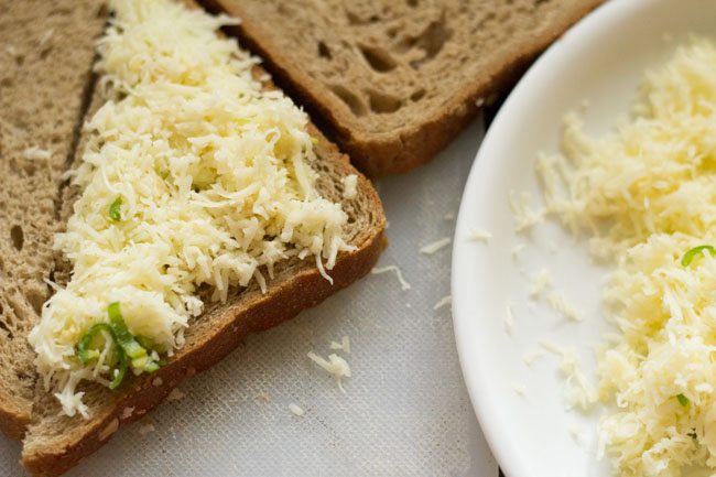 grated cheese spread on bread triangles. 