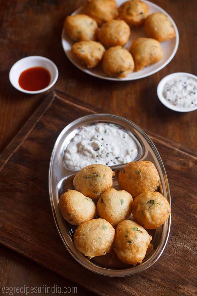 mix dal vada served on a steel plate with coconut chutney. 