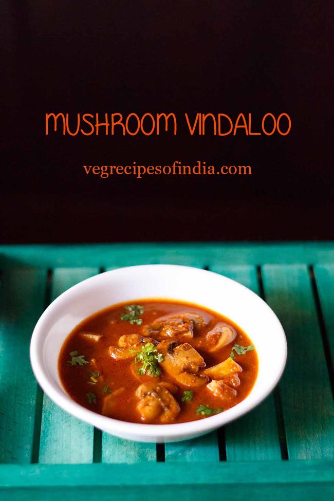 vindaloo recipe with mushrooms garnished with chopped coriander leaves and served in a white bowl on a green tray.