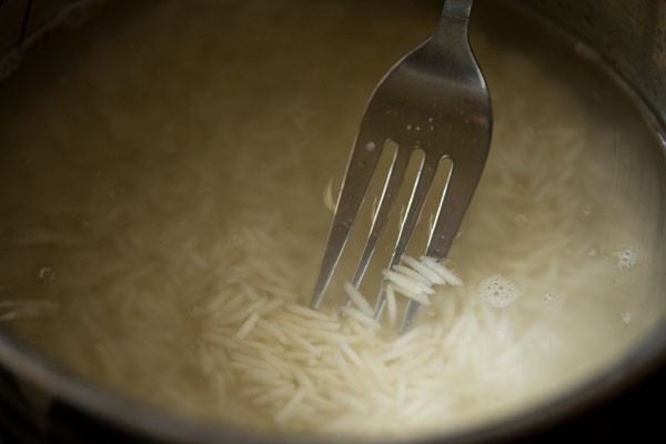 stirring rice grains with a fork. 