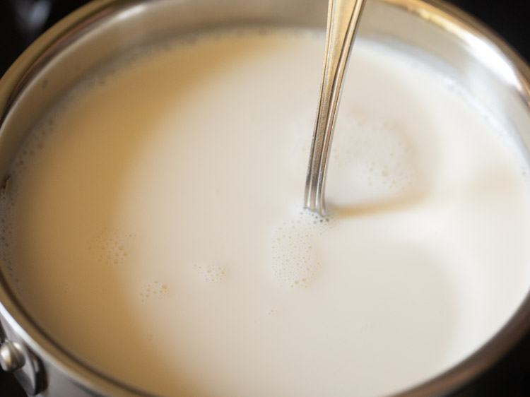 stirring milk with a steel spoon 