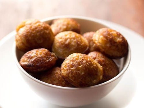 sweet paniyaram in a white bowl.