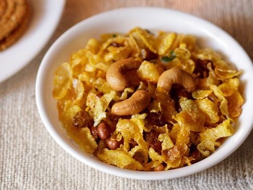 cornflakes chivda in a white bowl.