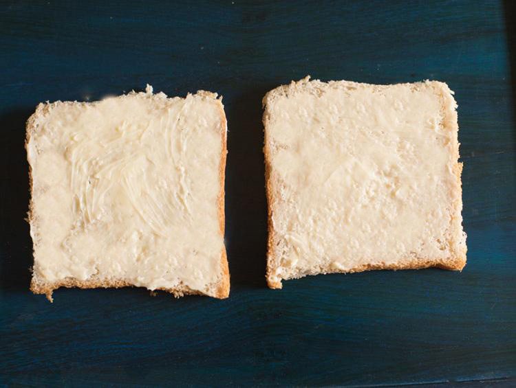 butter spread on bread slices.