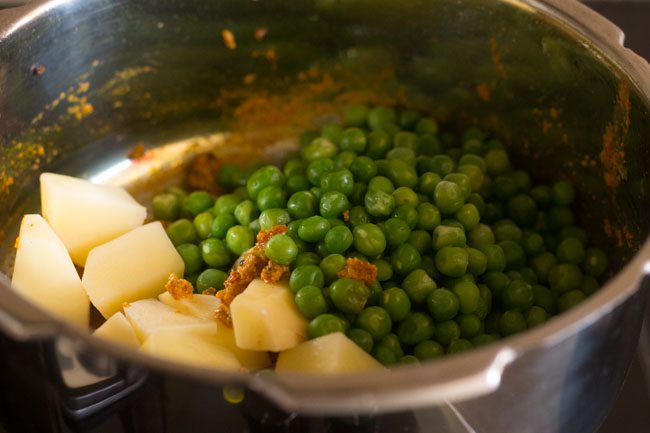 potato and peas added to the masala.