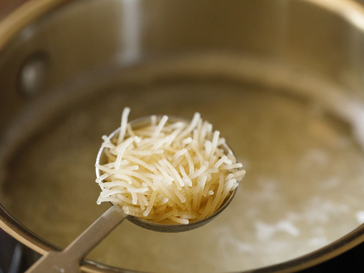 adding falooda sev to the hot boiling water