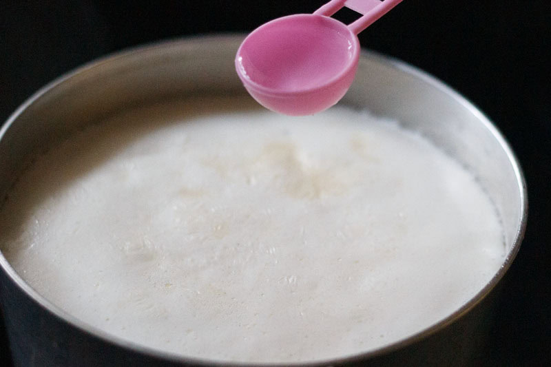 adding lemon juice or vinegar in boiling milk to curdle it. 