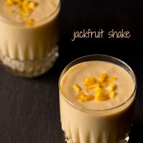 jackfruit shake topped with chopped jackfruit served in 2 glasses.