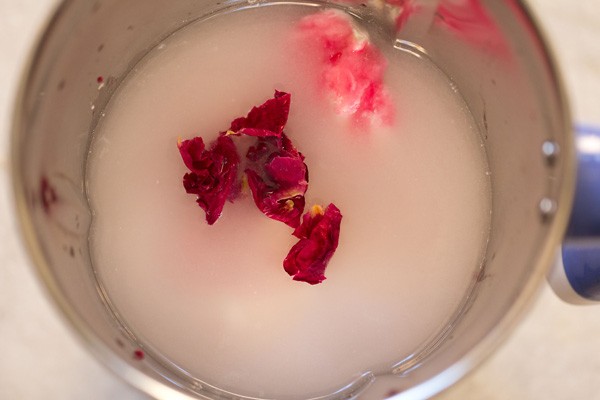 chilled water, dried rose petals, rose water and rose syrup added to blender jar. 