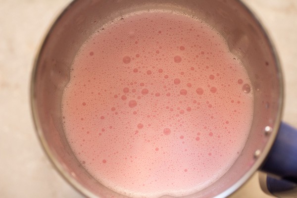 ingredients blended into a smooth and frothy rose lassi. 