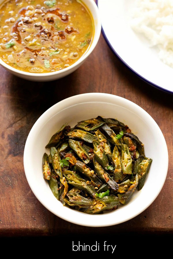 bhindi fry served in a white bowl.