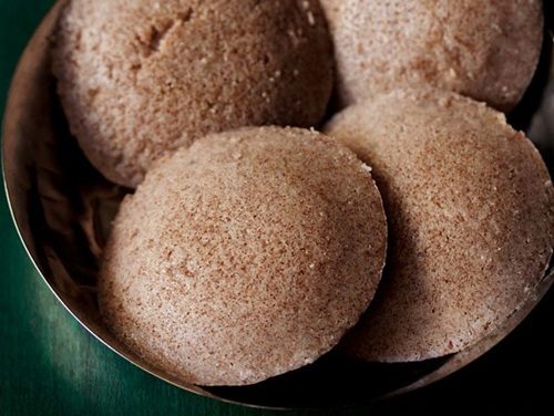 ragi idli served in a steel bowl.