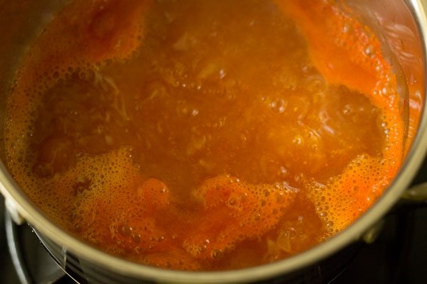 tomato broth simmering in pan. 