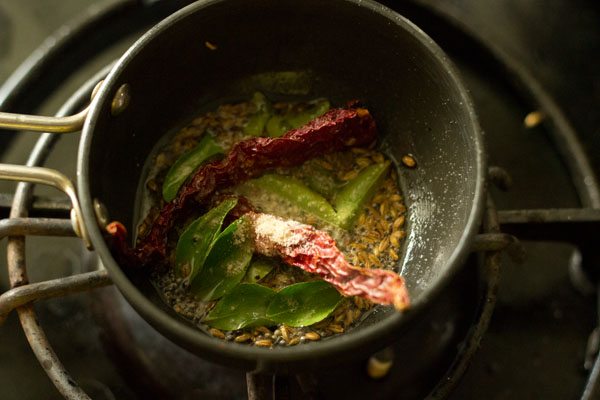 dried red chilies, curry leaves and asafoetida added to pan. 