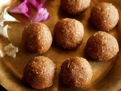 poha ladoo on a brass plate.