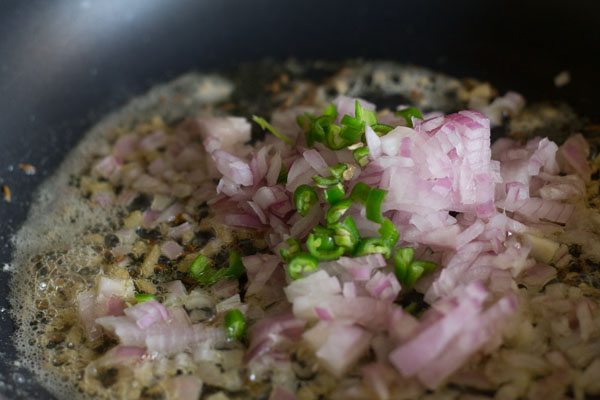 chopped onions and finely chopped green chilies added to pan. 