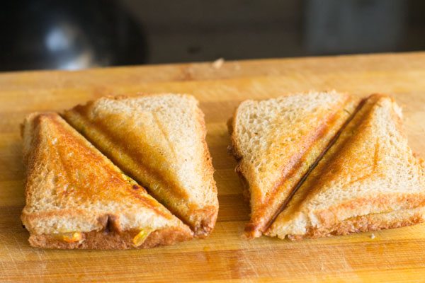 paneer bhurji sandwiches sliced into 2. 