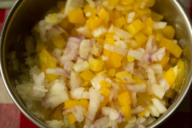 finely chopped yellow bell pepper and finely chopped onions added to mashed potatoes for aloo sandwich. 