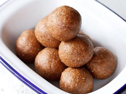 badam ladoo in a white rectangular container.