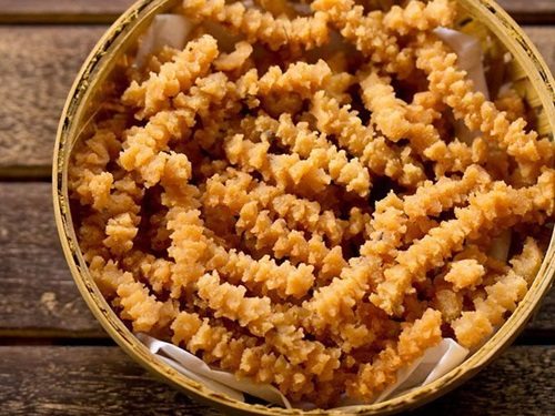 butter murukku served in a cane bowl.