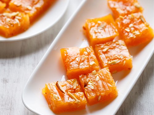 cubes of karachi halwa placed on a white tray.