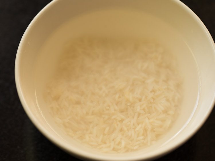 soaking rice in water for nolen gurer payesh. 