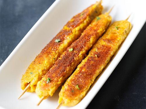 corn kabab on a white tray.