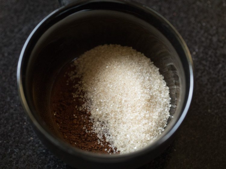 sugar and instant coffee granules in a mug.