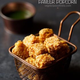 paneer popcorn served in a wired basket with a bowl of green chutney kept on the background and text layovers.
