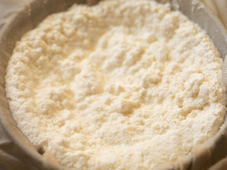 curdled milk poured on muslin cloth for making paneer cheese