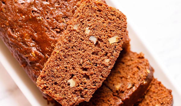 chocolate zucchini bread slice showing the texture kept on top of the zucchini bread loaf