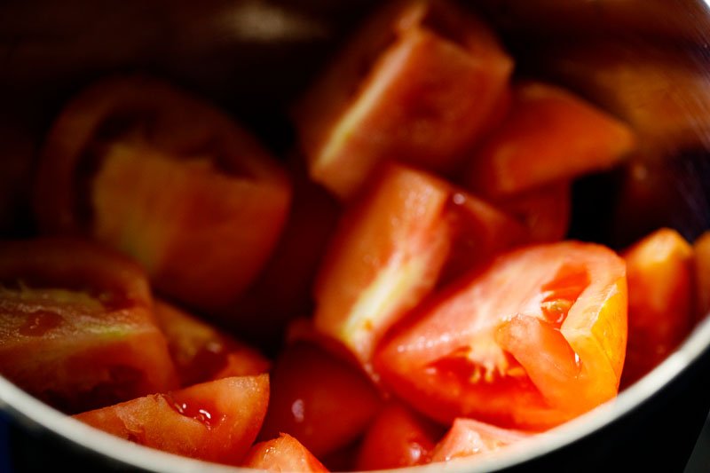 fresh tomatoes cut into wedges in the base of a blender