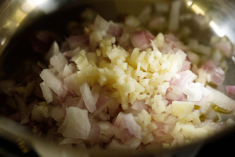 chopped raw onions and minced garlic added to skillet