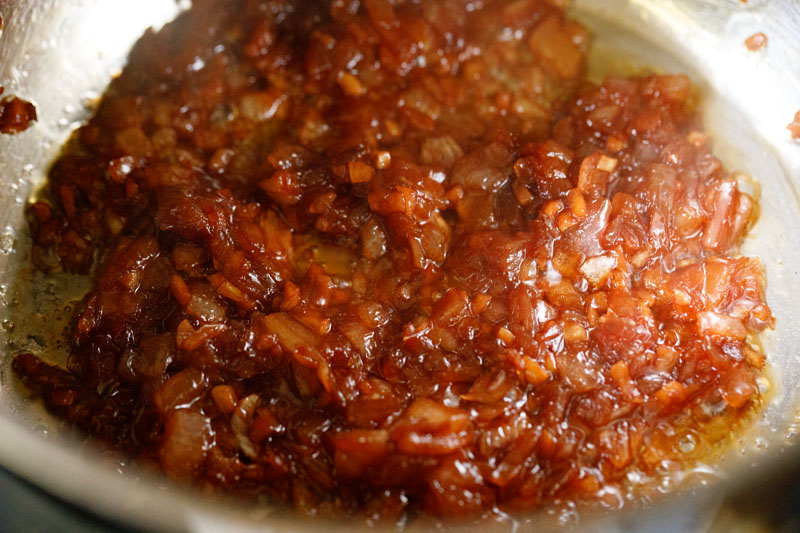 deeply caramelized onions and garlic after liquid from wine has evaporated - the color is rather dark golden red