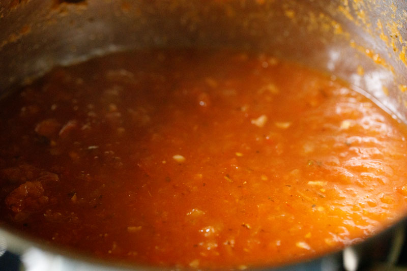 marinara sauce thickening and simmering in the skillet