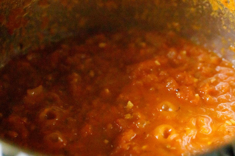 marinara sauce bubbling in the skillet