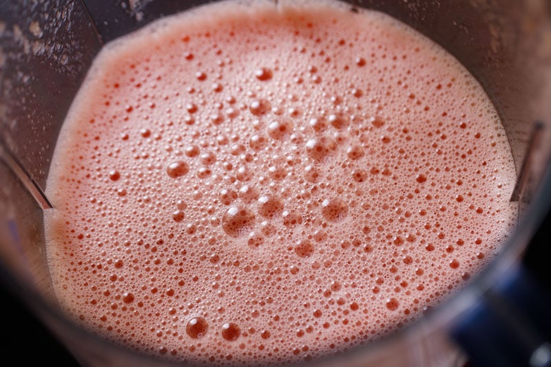 pink foamy top of watermelon juice after blending