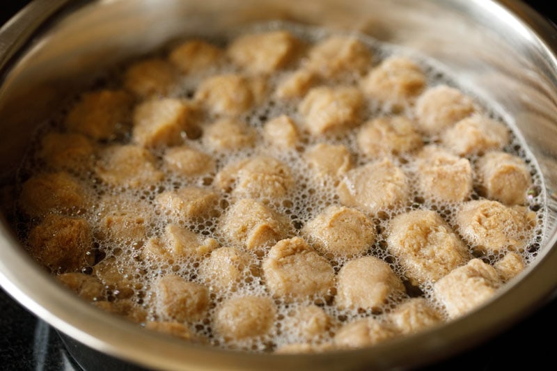 soya chunks being boiled in a pan to prepare for using in curry recipe