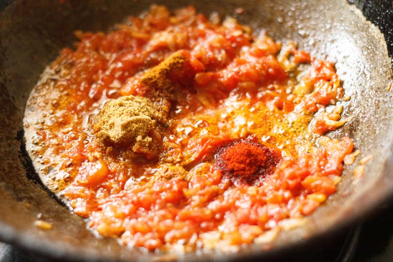 spice powders added to onion-tomato mixture. 