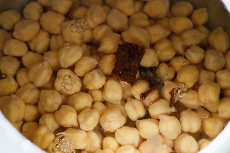 chana with spices, amla and water in cooker.