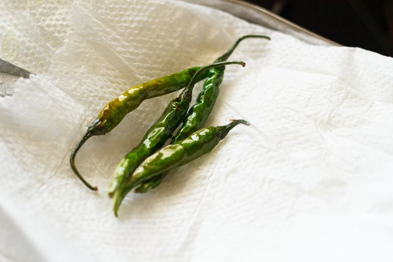 fried chillies on kitchen paper towels.