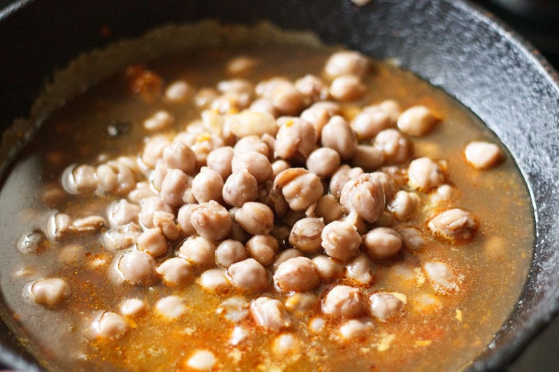 cooked chickpeas and water to onion-tomato masala.