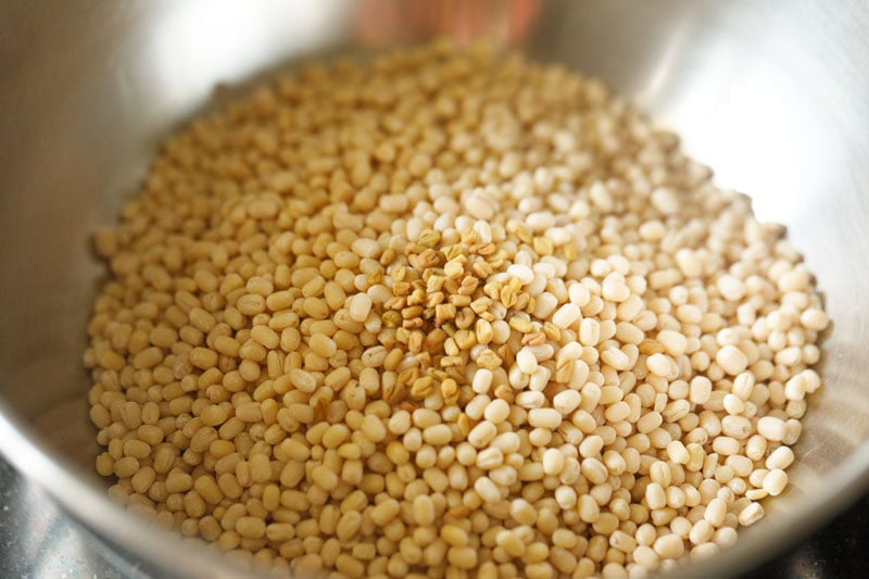 black gram and fenugreek seeds added in a bowl.