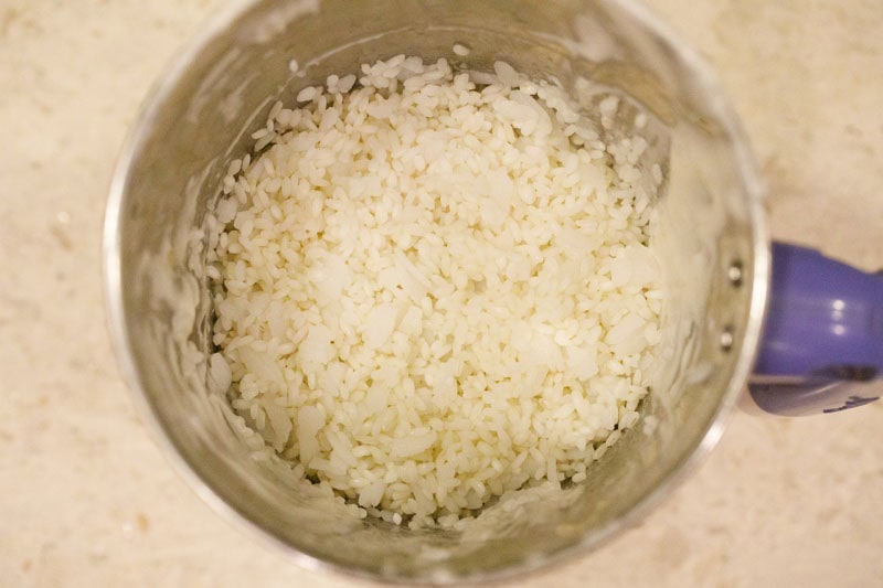 soaked idli rice and thick flattened rice added in mixer-grinder.