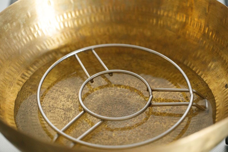 trivet placed inside water in a pan.