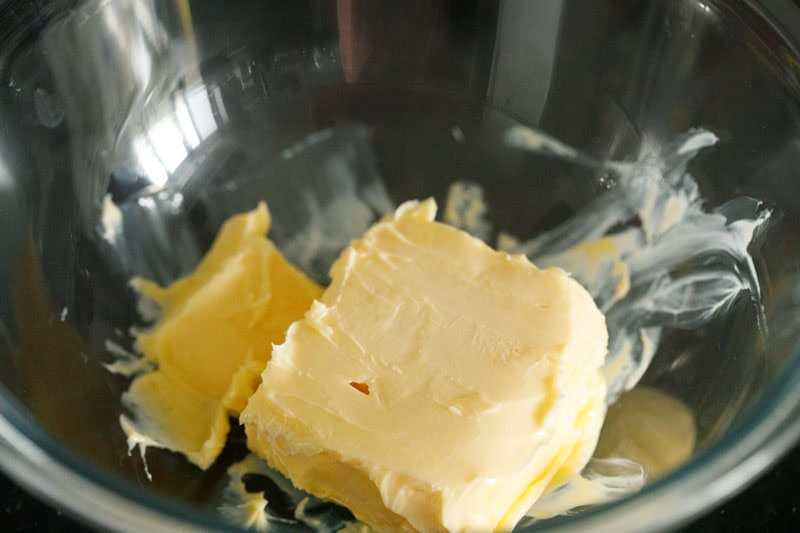 block of butter in a bowl to make buttercream frosting.