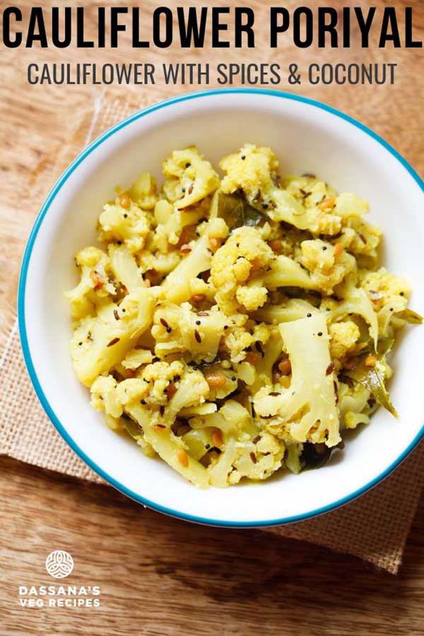 cauliflower poriyal in an aqua color rimmed white bowl on burlap.