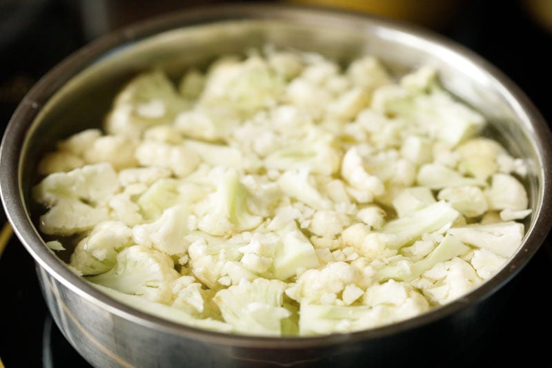 cauliflower florets immersed in hot water to make cauliflower poriyal.