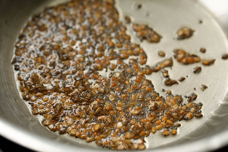 golden fried urad dal and cumin seeds in pan.