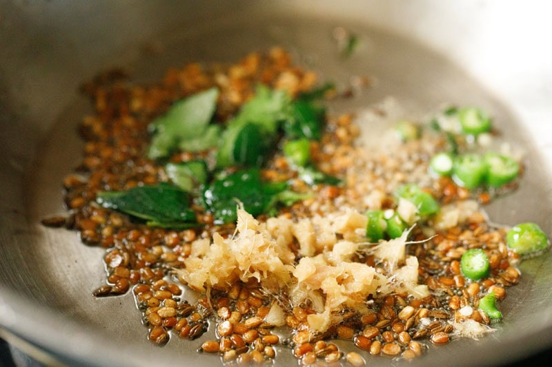 ginger, curry leaves and green chilies in pan.